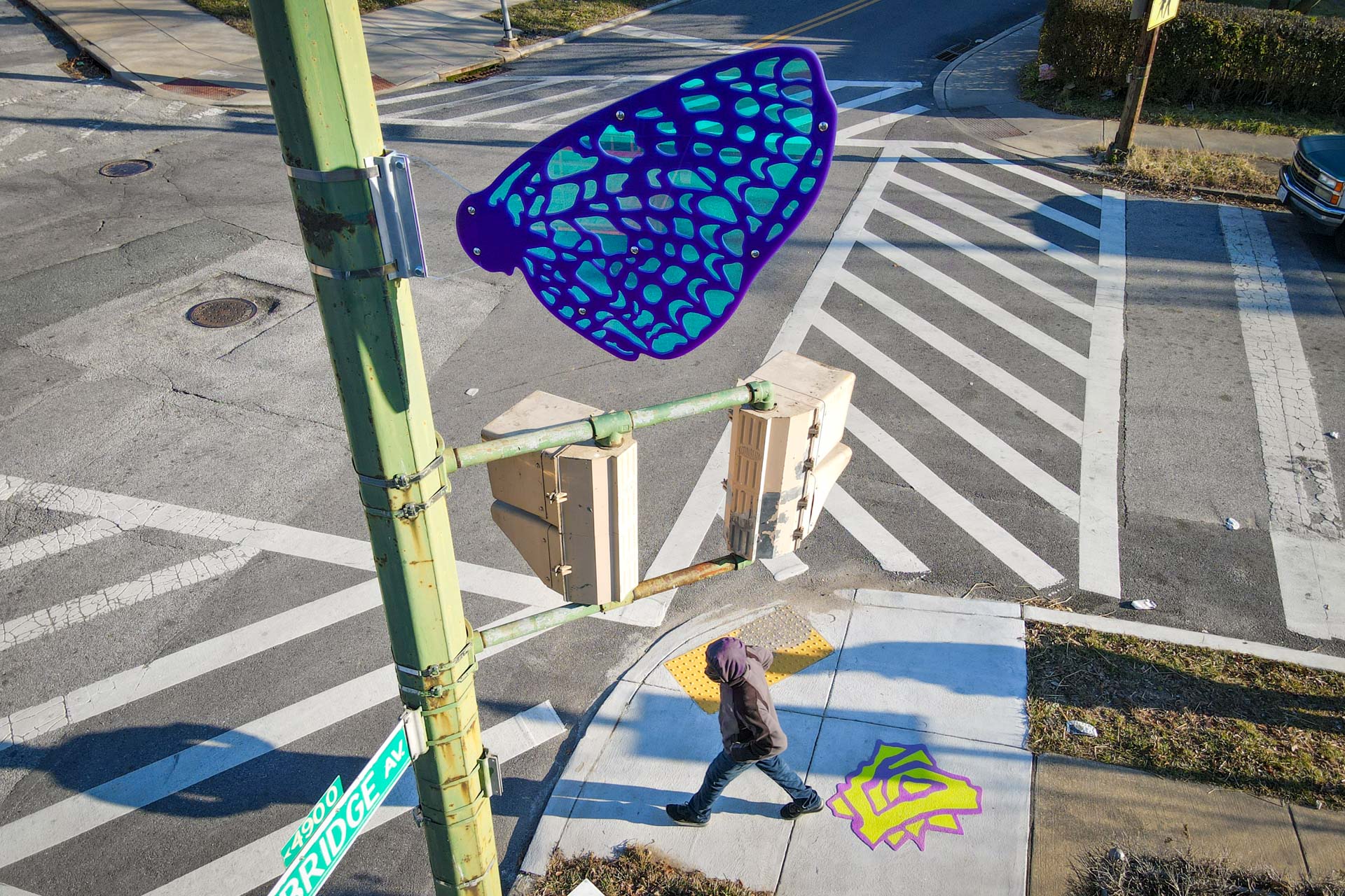 Pimlico Wayfinding butterfly sign and thermoplastic flower marker at Oakley and Pimlico with pedestrian