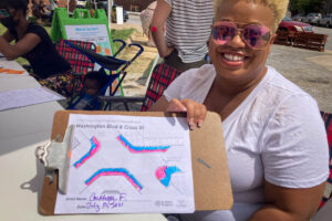 Pigtown Connects resident sharing crosswalk art drawing.