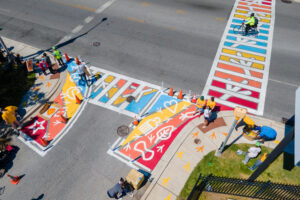 Unity Tracks traffic calming art crosswalk community paint day birds eye view