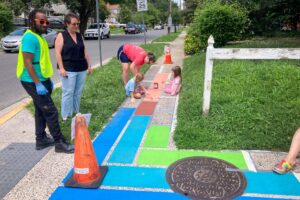 Hyattsville Quilted Crossing Graham Projects community paint day with Q helping residents paint sidewalk