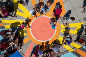 Highlandtown Park Shine overhead view of residents painting sun
