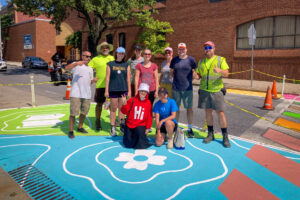 Reverberations Crosswalk group photo of community paint day volunteers