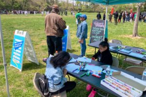 220430 We Love Towanda Pop-Up youth drawing under tent with football game in background