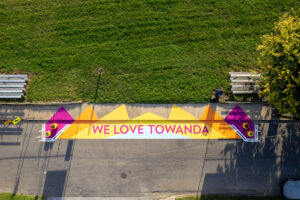 We Love Towanda drop off zone aerial view high showing pick up / drop off zone mural next to football field