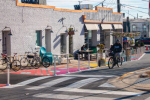 Hyattsville Bean There Sun That Vigilante Coffee parklet perspective with bike rider