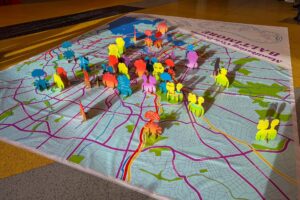 Manifesting Civic Dreams Baltimore map with golden hour shadows cast by colorful pop-up signs