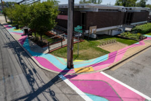 Reisterstown Rd Library Glen Flows art crosswalk and sidewalk mural birds eye view of street corner and crosswalk
