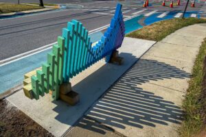 Annapolis Eastport Wave bench with golden hour shadows across sidewalk
