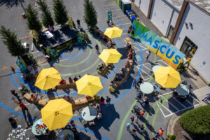 Damascus Placemaking Festival birds eye view of amphitheater with dancer performing in center and crowd sitting on hay bale ledges and Damscus mural in background