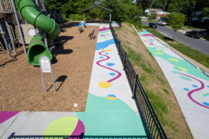 Valleywood Neighborhood Park Hopping Along pavement mural birds eye view facing west of sidewalk next to playground
