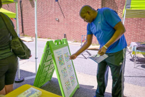 Lortz Lane LortzWave shared street pavement art community member sharing feedback on placemaking elements they would like to see in the public space during a community pop-up event on Lortz Lane