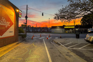 Lortz Lane LortzWave shared street pavement art perspective view of sunrise with outline of mural art chalked on pavement in foreground
