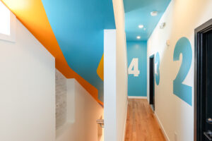 Second floor hallway of Trenton Art Garage apartments with colorful ceiling mural