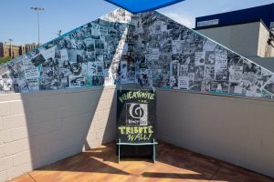 2700 Art Space ministage backdrop of wheatpasted flyers and photos from decades of local bands