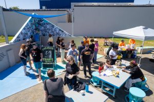 2700 Art Space participants wheatpasting the Inner Ear tribute wall birds eye view