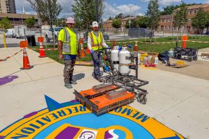 Chick Webb Recreation Center pavement art installation Liam operating infrared heater