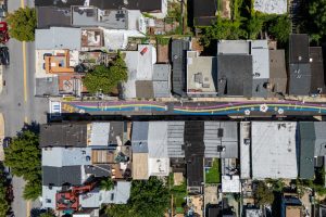 Lady Day Way Rhythm of Billie aerial view of north end with speed hump and hopscotch along music staff with gardenia flowers