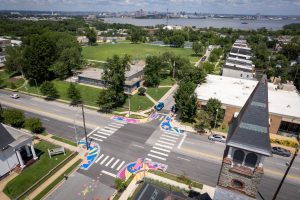 3rd & Patapsco Celestial Crossings birds-eye wide view of intersection with park and harbor in background