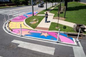 3rd & Patapsco Celestial Crossings perspective of child crossing on scooter at north corner